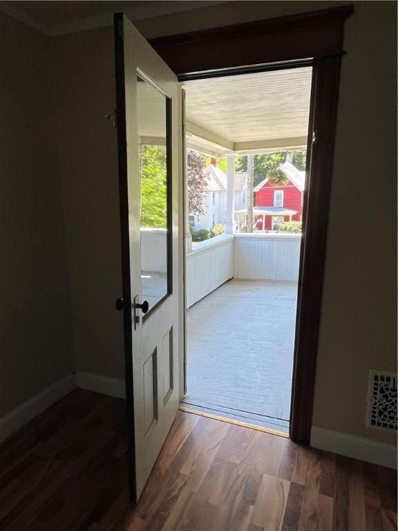 325 E 3rd St, Corning City, NY 14830 - doorway to outside with wood finished floors and baseboards