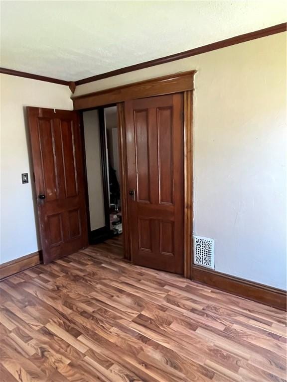 325 E 3rd St, Corning City, NY 14830 - spare room featuring wood finished floors and ornamental molding