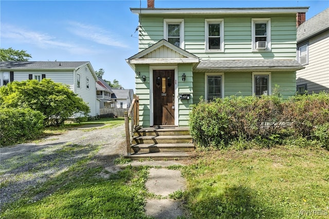 349 Willow St, Lockport City, NY 14094 - view of front of house with entry steps, a chimney, and cooling unit