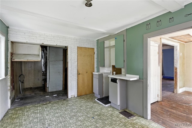 349 Willow St, Lockport City, NY 14094 - kitchen featuring ornamental molding, brick wall, and light countertops