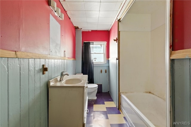 349 Willow St, Lockport City, NY 14094 - bathroom featuring tile patterned floors, vanity, a wainscoted wall, and wooden walls