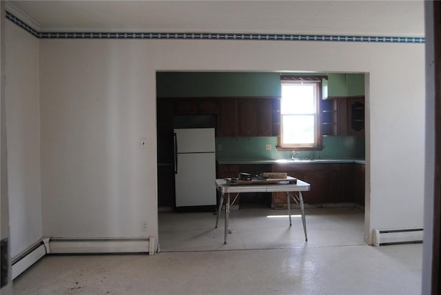 136 N Fraley St, Kane Boro, PA 16735 - kitchen featuring freestanding refrigerator, a baseboard radiator, light countertops, and dark brown cabinetry