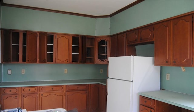 136 N Fraley St, Kane Boro, PA 16735 - kitchen featuring freestanding refrigerator, open shelves, ornamental molding, light countertops, and brown cabinetry