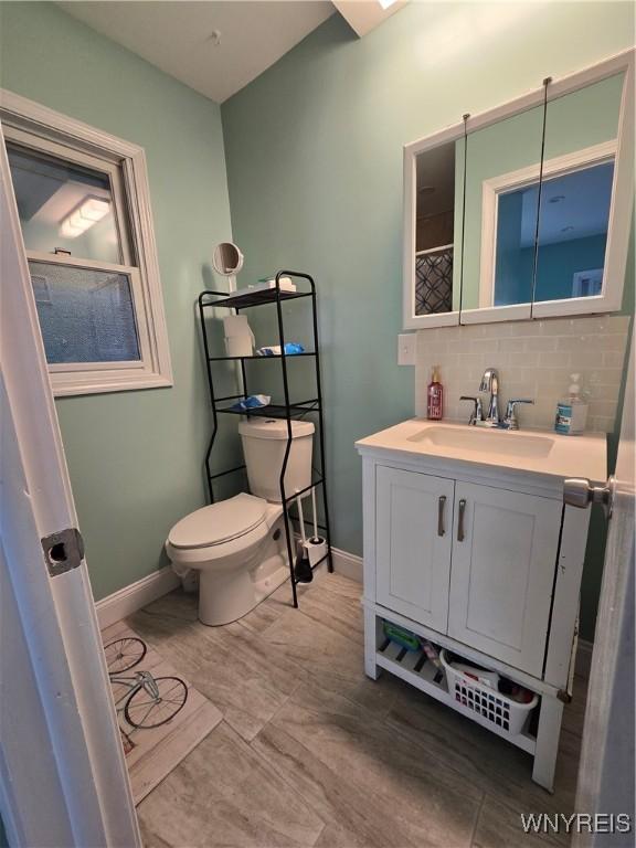 207 Shetland Dr, Amherst, NY 14221 - bathroom featuring vanity and decorative backsplash