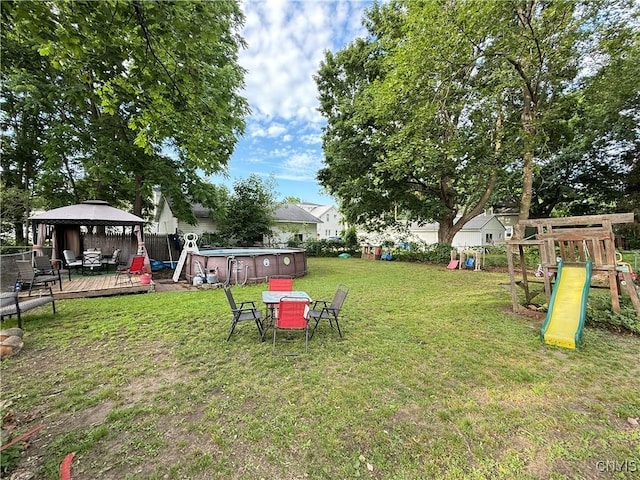 41 Owego St, Cortland, NY 13045 - fenced backyard with a gazebo, a playground, and a deck