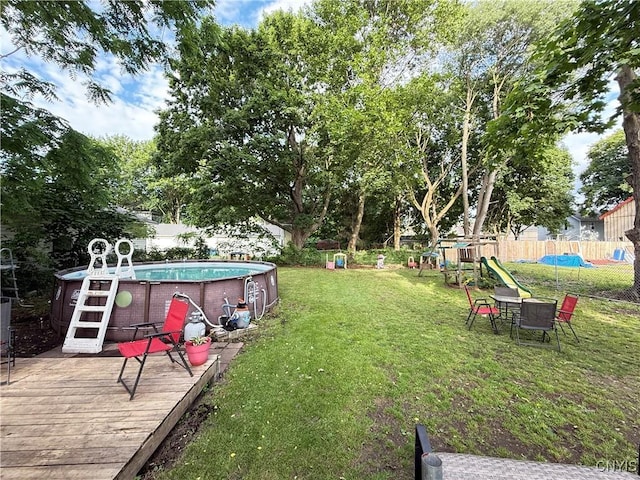 41 Owego St, Cortland, NY 13045 - fenced backyard featuring a deck and a playground