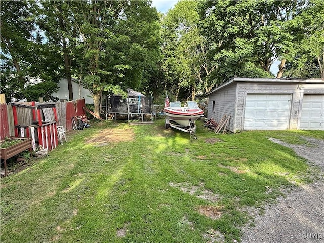 41 Owego St, Cortland, NY 13045 - view of yard with a trampoline, a detached garage, and an outdoor structure