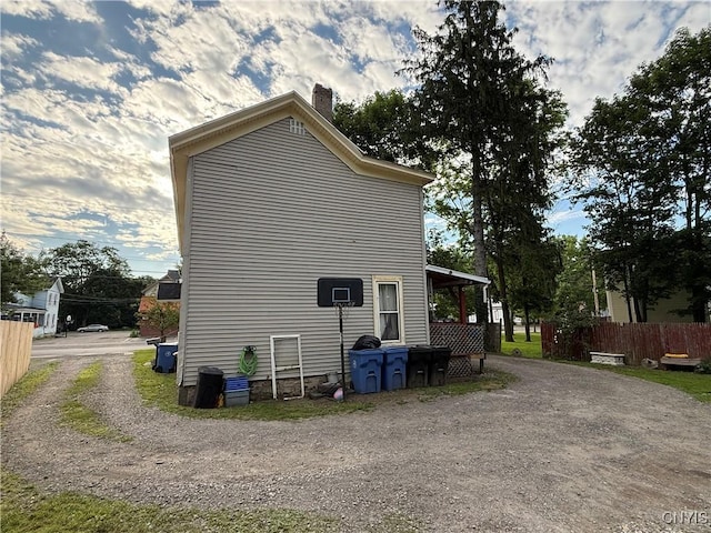 41 Owego St, Cortland, NY 13045 - view of home's exterior featuring a chimney and driveway