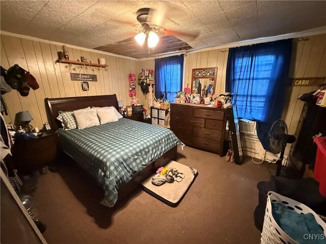 41 Owego St, Cortland, NY 13045 - carpeted bedroom with wooden walls and a ceiling fan