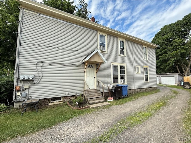 41 Owego St, Cortland, NY 13045 - view of front of property with entry steps, driveway, an outdoor structure, and a chimney