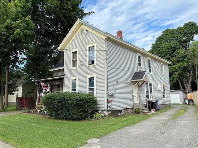 41 Owego St, Cortland, NY 13045 - view of side of home with a chimney, an outdoor structure, a lawn, and driveway