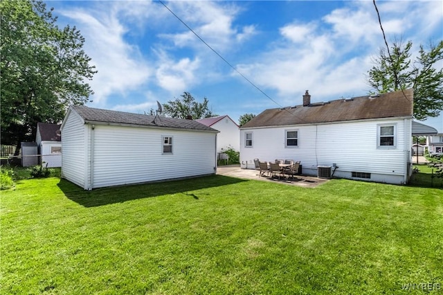 686 Harrison Ave, Tonawanda, NY 14223 - rear view of property with an outdoor structure, a patio area, and a chimney