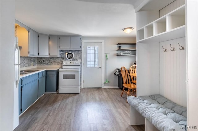686 Harrison Ave, Tonawanda, NY 14223 - kitchen with white appliances, wood finished floors, tasteful backsplash, light countertops, and gray cabinets