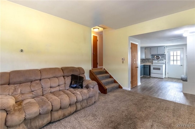 686 Harrison Ave, Tonawanda, NY 14223 - living room with dark carpet and stairway
