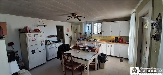 4604 W Railroad Ave, Stockton, NY 14874 - kitchen with freestanding refrigerator, white cabinets, light countertops, and ceiling fan
