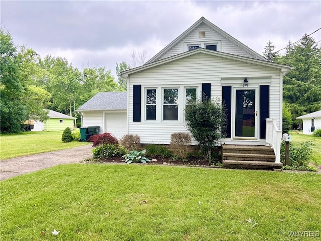 575 Willow Ave, North Tonawanda, NY 14120 - view of front of home featuring a garage, driveway, and a front lawn