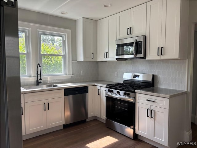 575 Willow Ave, North Tonawanda, NY 14120 - kitchen with stainless steel appliances, dark wood-style floors, light countertops, backsplash, and recessed lighting