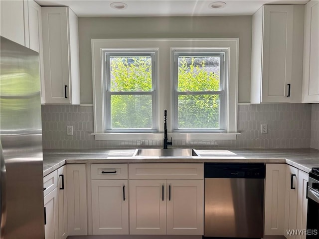 575 Willow Ave, North Tonawanda, NY 14120 - kitchen featuring stainless steel appliances, light countertops, white cabinetry, and decorative backsplash