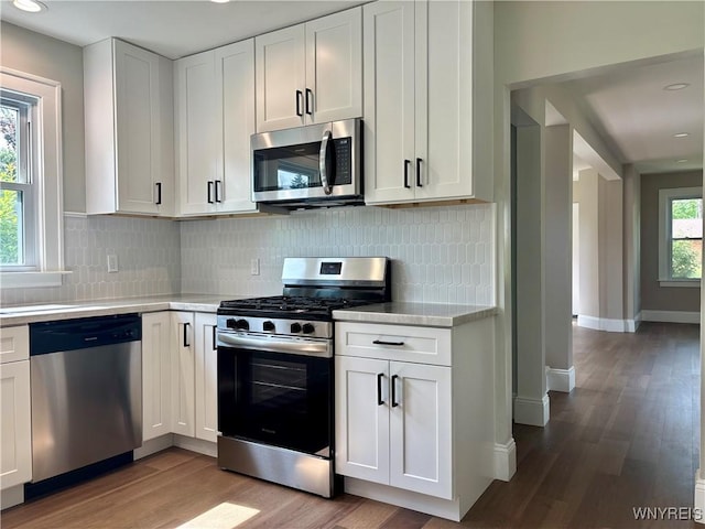 575 Willow Ave, North Tonawanda, NY 14120 - kitchen with appliances with stainless steel finishes, light wood finished floors, light countertops, white cabinets, and recessed lighting