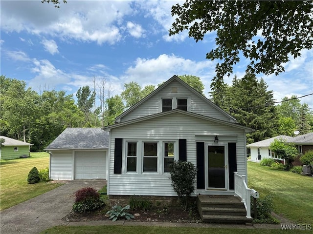 575 Willow Ave, North Tonawanda, NY 14120 - bungalow-style house featuring asphalt driveway, a front yard, entry steps, and a garage