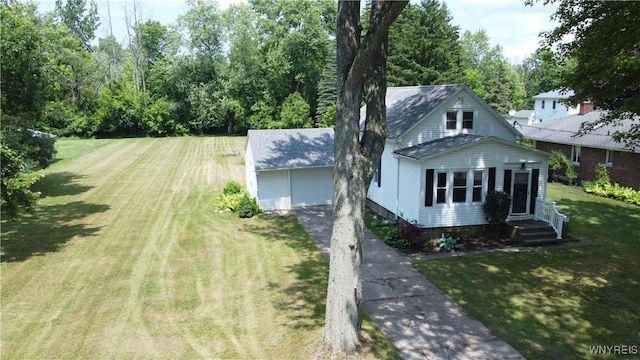 575 Willow Ave, North Tonawanda, NY 14120 - view of front of home with an outbuilding, a front yard, asphalt driveway, and a detached garage