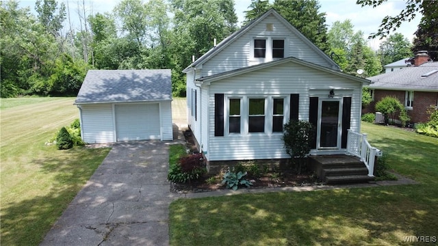 575 Willow Ave, North Tonawanda, NY 14120 - bungalow-style home featuring an outbuilding, asphalt driveway, a detached garage, and a front lawn