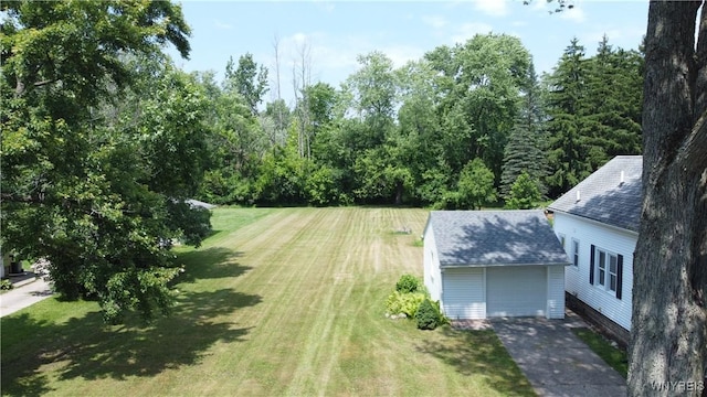 575 Willow Ave, North Tonawanda, NY 14120 - view of grassy yard with driveway and a garage