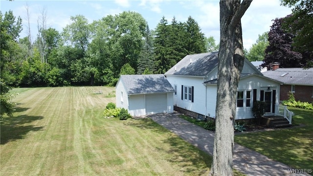 575 Willow Ave, North Tonawanda, NY 14120 - view of home's exterior featuring driveway, an outdoor structure, a yard, and an attached garage