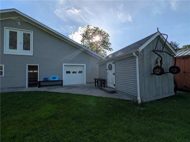 15 Clark Dr, Otto Twp, PA 16745 - view of property exterior featuring a yard, an outdoor structure, a garage, and driveway