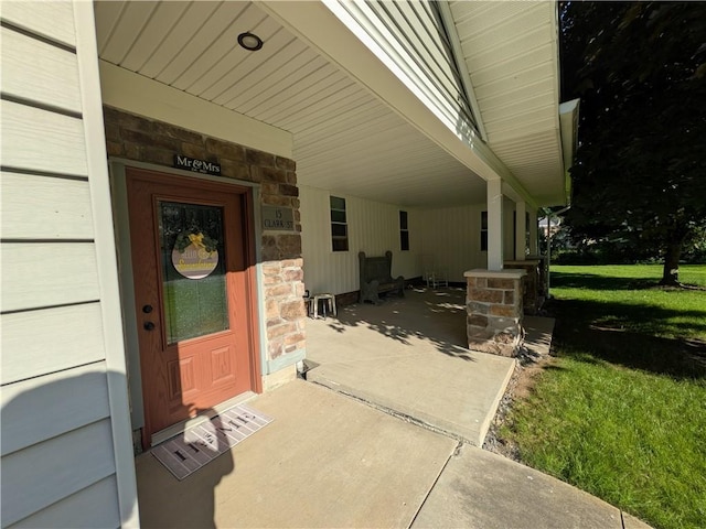 15 Clark Dr, Otto Twp, PA 16745 - view of exterior entry with stone siding and a lawn