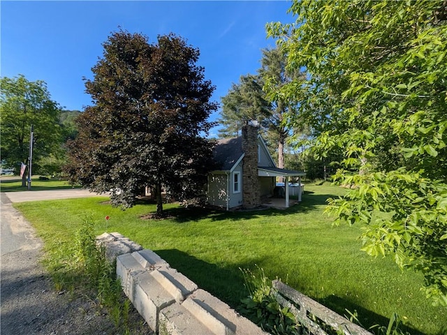 15 Clark Dr, Otto Twp, PA 16745 - view of side of property with a yard and a chimney
