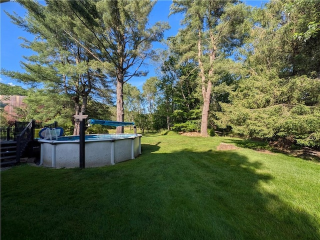 15 Clark Dr, Otto Twp, PA 16745 - view of green lawn with an outdoor pool and a deck