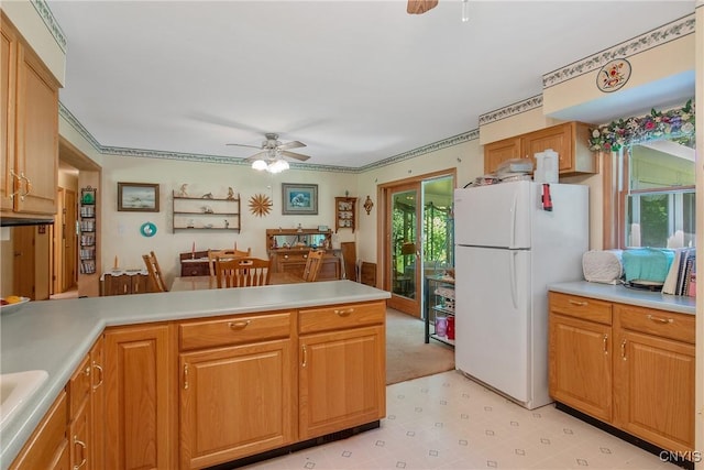 123 Town Line Rd, Volney, NY 13069 - kitchen featuring freestanding refrigerator, ceiling fan, light countertops, a peninsula, and ornamental molding