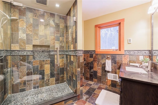 42 Lake Lacoma Dr, Perinton, NY 14534 - bathroom with tile walls, double vanity, a stall shower, and wainscoting