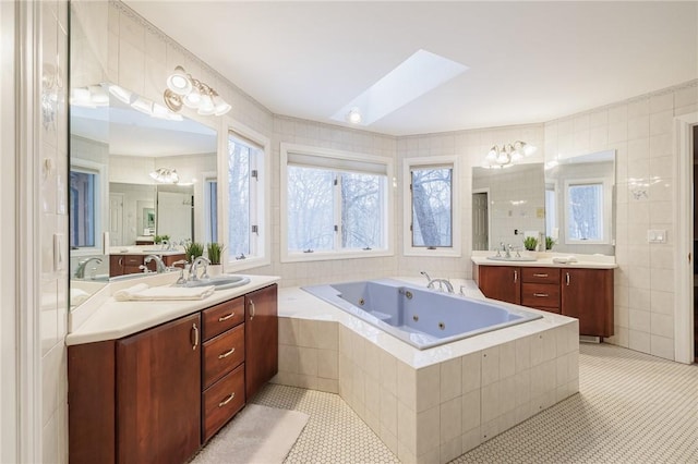 42 Lake Lacoma Dr, Perinton, NY 14534 - full bath with two vanities, a tub with jets, tile walls, a skylight, and tile patterned flooring