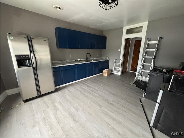 926 Burnet Ave Unit 30, Syracuse, NY 13203 - kitchen with stainless steel refrigerator with ice dispenser, blue cabinetry, light countertops, and light wood-style floors