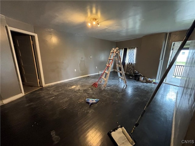 926 Burnet Ave Unit 30, Syracuse, NY 13203 - unfurnished living room featuring baseboards and wood finished floors