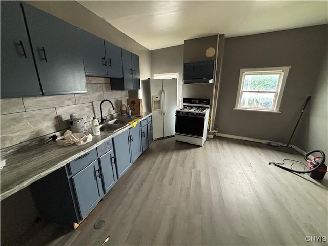 926 Burnet Ave Unit 30, Syracuse, NY 13203 - kitchen featuring white appliances, light wood finished floors, tasteful backsplash, blue cabinetry, and exhaust hood