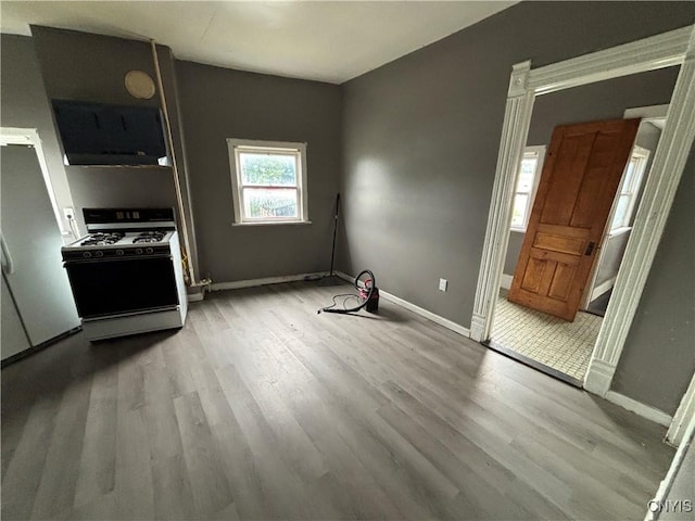 926 Burnet Ave Unit 30, Syracuse, NY 13203 - kitchen featuring gas range, extractor fan, and wood finished floors