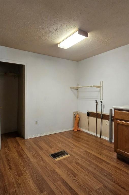 12655 Berwick, Tpke, PA 16925 - basement with a textured ceiling and wood finished floors