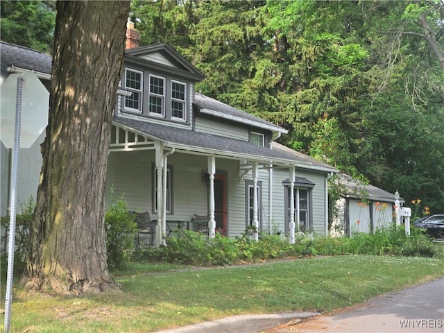 720 Main St, Porter, NY 14174 - view of front of home featuring covered porch, a chimney, a front yard, and a shingled roof