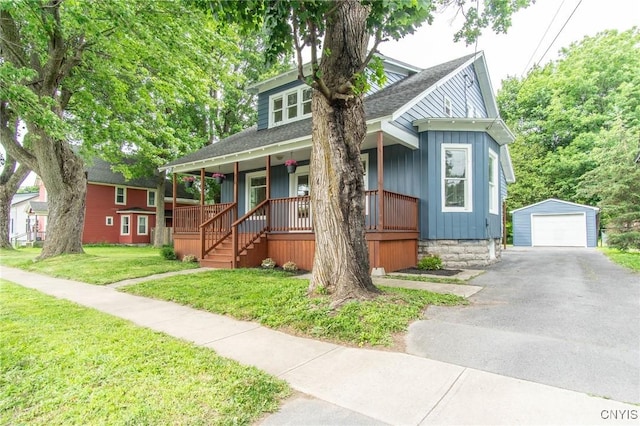 810 Superior St, Watertown City, NY 13601 - bungalow featuring covered porch, an outdoor structure, driveway, roof with shingles, and a detached garage
