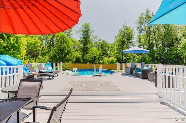 20040 Morin Ln S, Hounsfield, NY 13685 - view of pool with a wooden deck, view of wooded area, and an outdoor hangout area