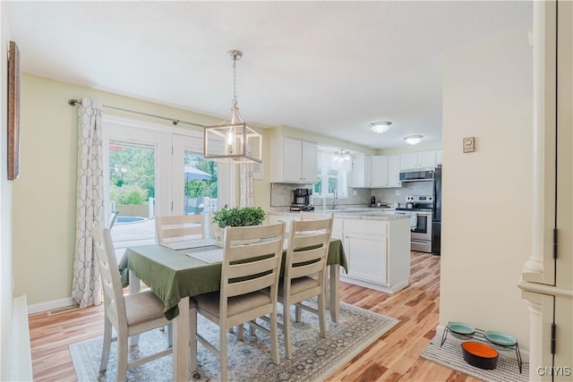 20040 Morin Ln S, Hounsfield, NY 13685 - dining room with light wood-style flooring and baseboards