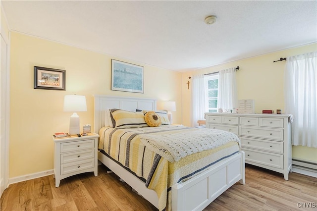 20040 Morin Ln S, Hounsfield, NY 13685 - bedroom with light wood-style flooring and a baseboard heating unit