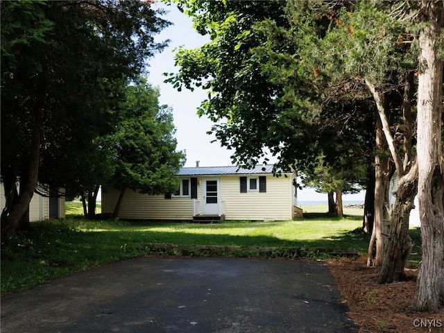 5366 Clark Point Rd, Henderson, NY 13651 - view of front of property featuring entry steps, a front yard, and a metal roof