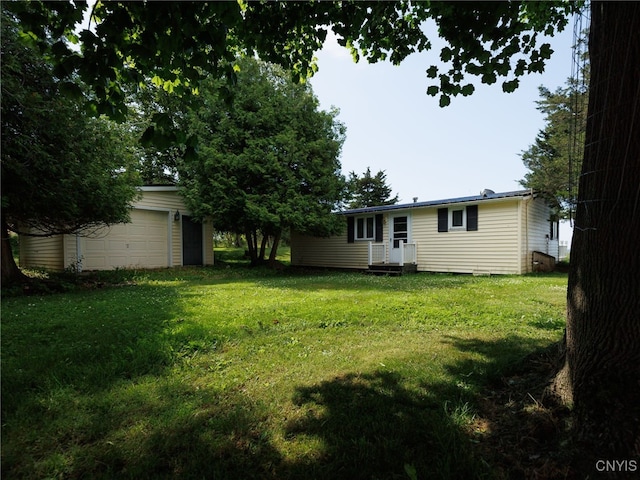 5366 Clark Point Rd, Henderson, NY 13651 - view of green lawn featuring an outbuilding and a garage