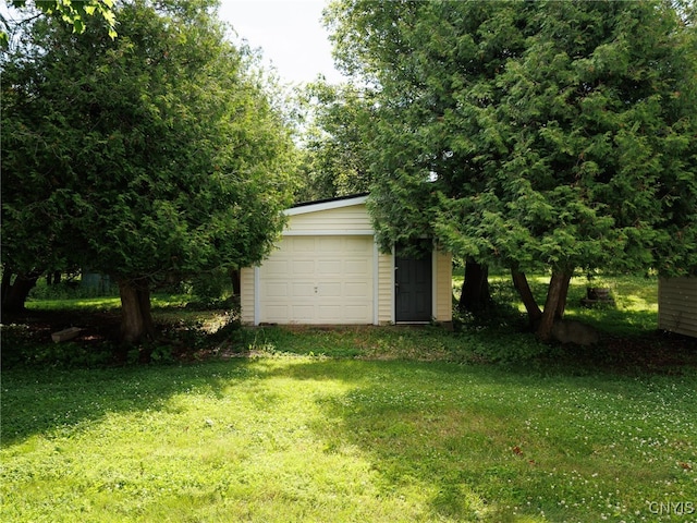 5366 Clark Point Rd, Henderson, NY 13651 - view of green lawn with an outdoor structure and a garage