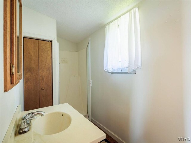 5366 Clark Point Rd, Henderson, NY 13651 - bathroom with vanity and a textured ceiling