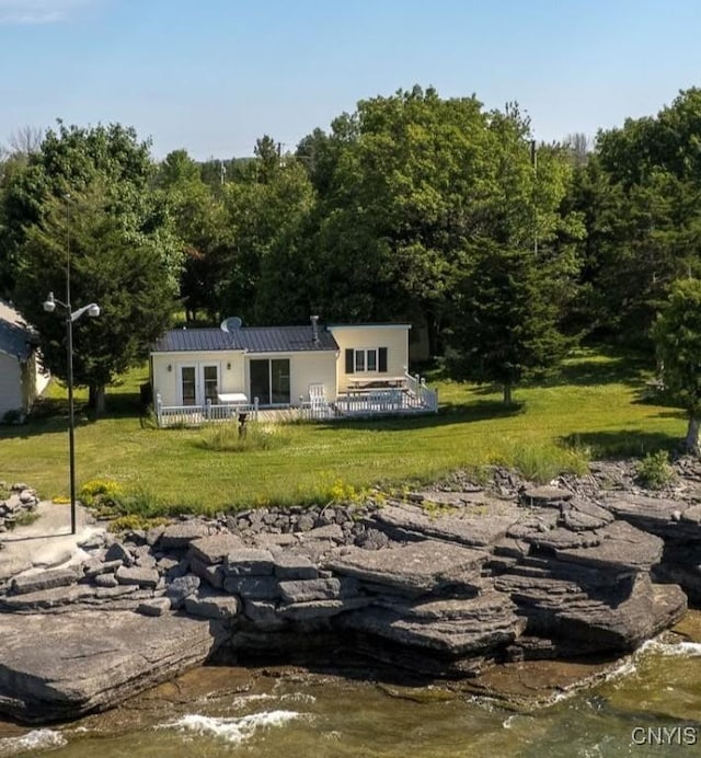 5366 Clark Point Rd, Henderson, NY 13651 - rear view of house with a lawn, a metal roof, and a wooded view